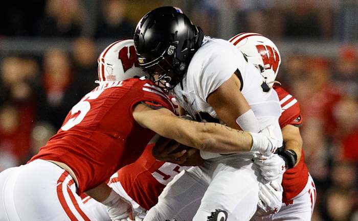 Oct 16, 2021; Madison, Wisconsin, USA; Army Black Knights running back Tyson Riley (32) is tackled by Wisconsin Badgers linebacker Leo Chenal (5) during the first quarter at Camp Randall Stadium. Mandatory Credit: Jeff Hanisch-USA TODAY Sports